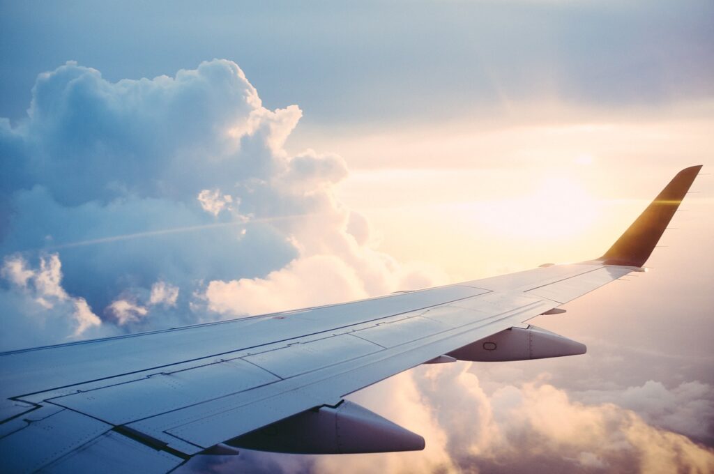 A plane is flying above the clouds