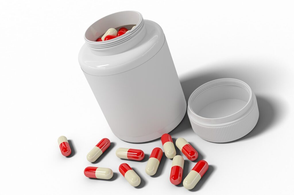 A white jar with uncountful pills on the white table.