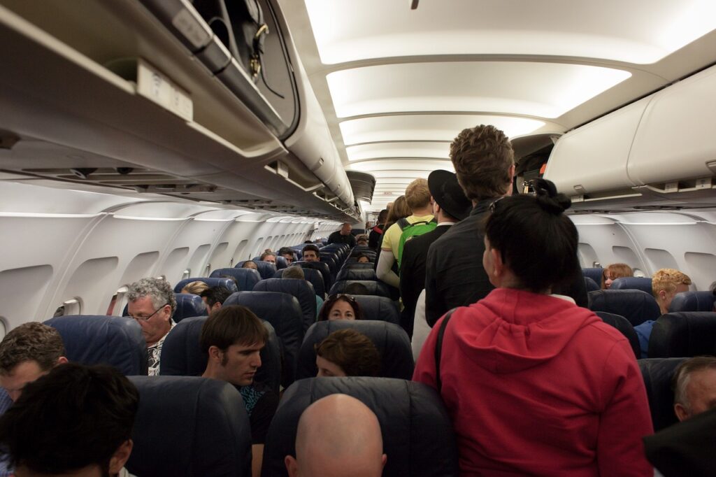 Passengers are walking through in the plane.